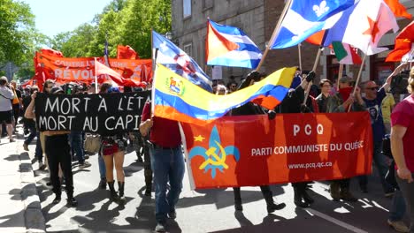 People-gather-to-march-along-road-at-G7-summit-carrying-patriotic-flags