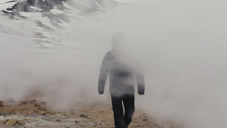 Tourist-appear-from-white-dense-steam-vapor-at-Myvatn-geothermal-area