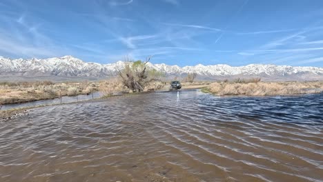 Overland-truck-driving-through-a-creak-in-slow-motion