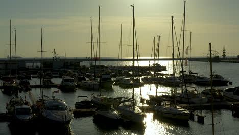 Schwenkansicht-Des-Yachthafens-Und-Der-Angedockten-Segelboote-Bei-Sonnenuntergang