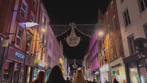 A-4K-walk-down-Grafton-St-Dublin-Ireland-following-three-girls-window-shopping-and-Gards-patrolling