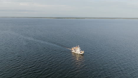 Slow-aerial-video-following-a-ship-that-is-moving-along-the-Amazon-River-in-the-light-of-the-sunrise
