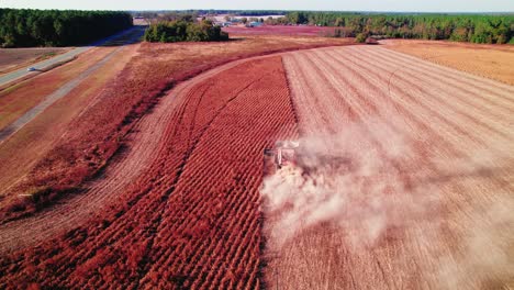 Harvester-at-work-in-soybean-field-with-vibrant-soil-contrast---Georgia,-USA