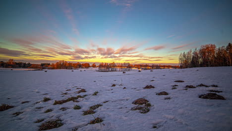 Timelapse-shot-of-white-clouds-passing-over-snow-covered-farmlands-on-a-cold-winter-day