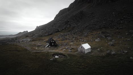 Aerial-abandoned-house-and-chapel-in-rural-rocky-mountain-landscape-scenery