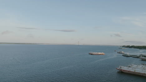 Aerial-video-of-ships-docked-on-the-Amazon-River-with-the-Rio-Negro-Bridge-in-the-background