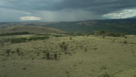 Rain-Storm-On-Green-Mountain-Horizon-In-Distance,-Costa-Rica-Drone-Flyover