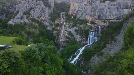 Aerial-view-of-Ujevara-E-Sotires-waterfalls-near-Progonat-village-in-Nivica-Canyon,-a-stunning-natural-landscape