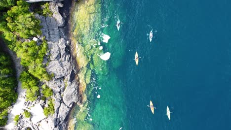 Kayak-along-rocky-coast-in-crystal-clear-waters