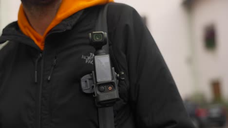 Turning-On-DJI-Osmo-Pocket-3-Attached-To-Camera-Clip-On-Backpack
