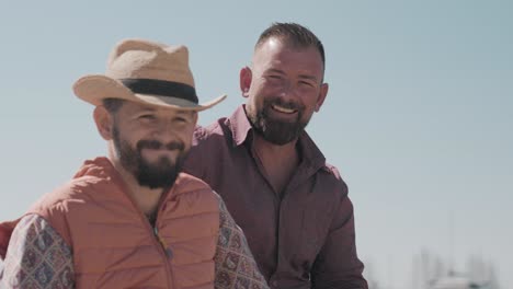 Pair-of-friends-riding-horses-and-smiling-at-the-cameras-during-the-Palavas-Les-Flots-fair-on-the-French-Mediterranean-coast