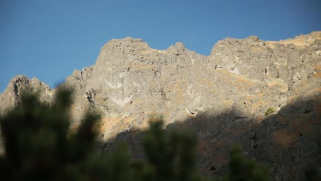 Cloud-shadows-climb-and-creep-up-exposed-granite-mountain-cliff-ridges-in-Sliezsky-Dom,-High-Tatras-Slovakia