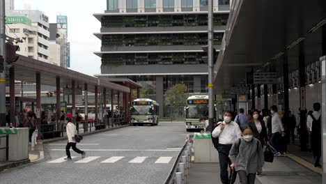 Locals-And-Commuters-Crossing-Road-At-Hiroshima-Bus-Station-Terminal-In-The-Afternoon