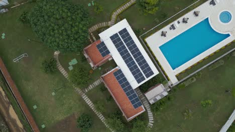Club-house-in-a-residential-area-with-a-roof-covered-with-photovoltaic-solar-panels,-produce-clean-and-ecological-electricity-in-the-suburban-rural-area-of-Jamundí,-Valle-del-Cauca