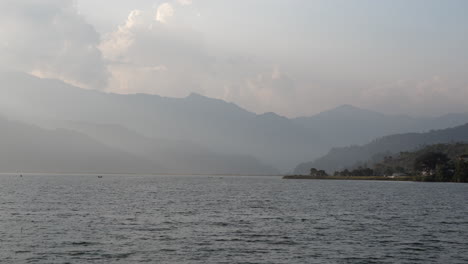 A-panning-view-of-Fewa-Lake-in-Pokhara,-Nepal-in-the-late-evening-light