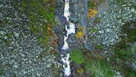 Bird's-Eye-View-Of-A-River-Stream-On-Rocky-Terrain-During-Rainy-Day-In-Sweden