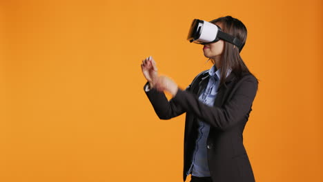 Asian-employee-checks-virtual-reality-goggles-on-camera