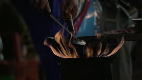 Man-cooking-noodle-dish-in-wok-on-open-fire-Thailand