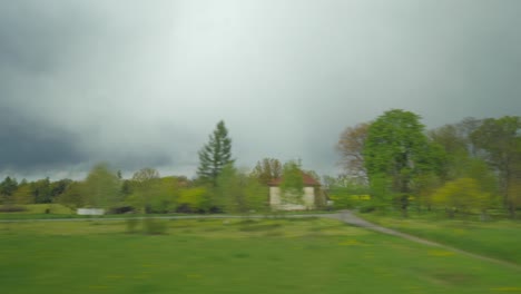 Shot-of-moving-countryside-landscape-from-window-of-train-Vienna-Austria