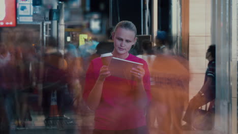 Timelapse-of-woman-with-touch-pad-in-crowded-street