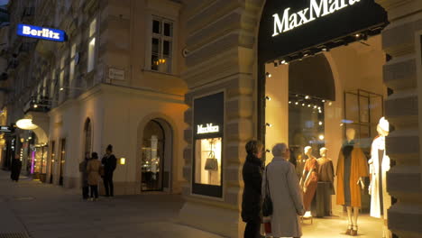 Women-at-show-window-of-the-store-at-night