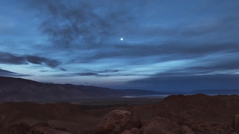 Famous-and-iconic-rocks-of-Alabama-Hills-with-a-full-moon-starting-to-light-up-during-blue-hour