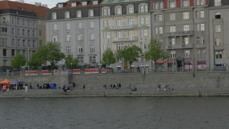 Blick-Vom-Boot,-Das-Sich-Auf-Der-Moldau-Entlang-Des-Resident-Hotel-Standard-Und-Des-Damms-In-Prag,-Tschechische-Republik,-Bewegt