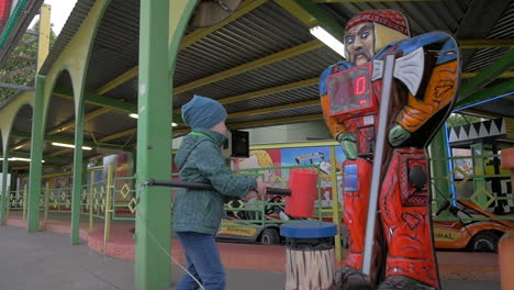 Vista-En-Cámara-Lenta-De-Un-Niño-Pequeño-Golpeando-Con-Un-Juego-De-Martillo-De-Juguete-En-El-Parque-De-Atracciones-Viena-Austria