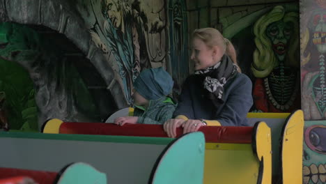 Mother-and-son-riding-out-child-labyrinth-in-amusement-park