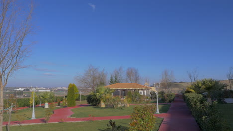 Picturesque-panoramic-landscape-of-park-with-tropical-trees-grass-pavilion-and-in-Nea-Kallikratia-Greece