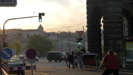 View-of-road-intersection-with-red-traffic-light-cars-horse-carriage-and-tram-Prague-Czech-Republic