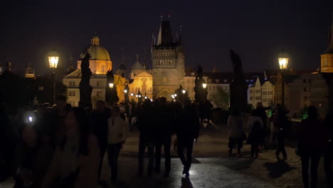 Night-view-of-Charles-Bridge-with-people-Prague
