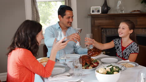 Jewish-family-making-a-toast-before-their-Shabbat-meal