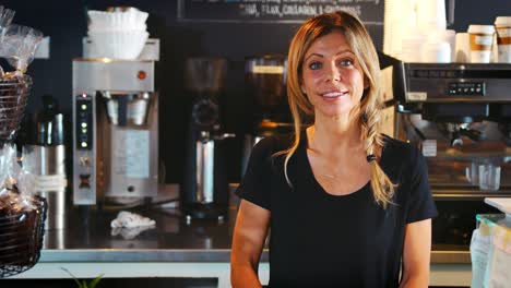 Portrait-Of-Female-Barista-Behind-Counter-In-Coffee-Shop