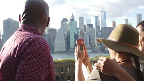 Tourist-Taking-Photo-Of-Manhattan-Skyline-On-Mobile-Phone