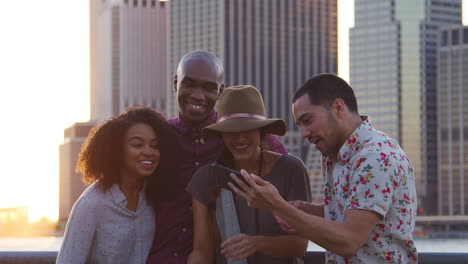 Group-Of-Friends-Posing-For-Selfie-In-Front-Of-Manhattan-Skyline