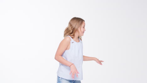 Girl-Walks-Into-Shot-And-Poses-Against-White-Studio-Background
