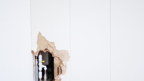 Damaged-Wall-With-Leaking-Water-Pipe-And-Toolbox
