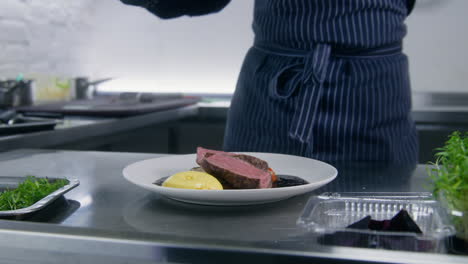 Zoom-in-of-the-Cook-Pouring-Sauce-on-Plate-with-Beef-Steak