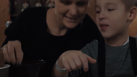 Mom-and-kid-decorating-cookie-with-sugar-sprinkles