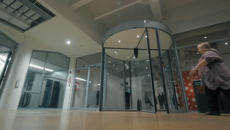 Some-people-walking-through-revolving-doors-in-HAM-Finland