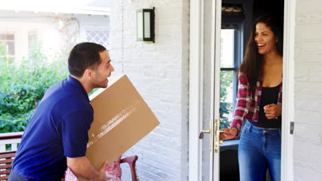 Courier-Delivering-Package-To-Woman-At-Home