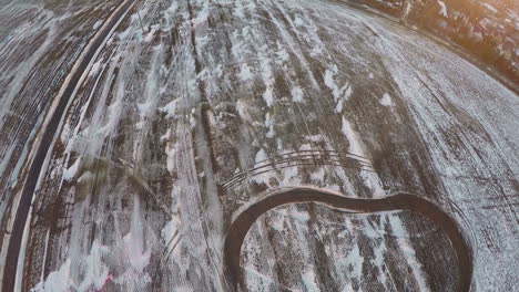 Aerial-view-of-snowy-fields-near-township-Winter-scene-in-Russia