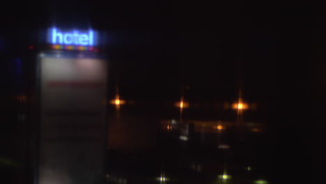 Night-street-view-with-illuminated-hotel-banner