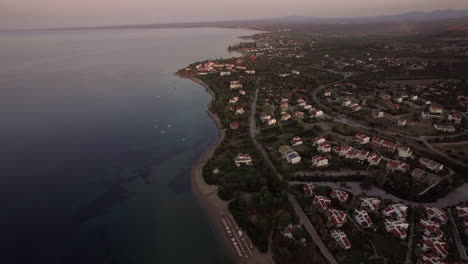 Toma-Aérea-De-Cabañas-A-Lo-Largo-De-La-Costa-De-La-Playa-De-Trikorfo,-Grecia