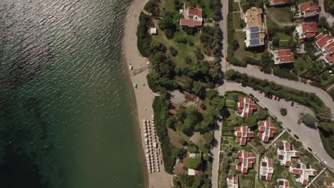 Aerial-shot-of-resort-town-with-cottages-on-sea-coast-Greece