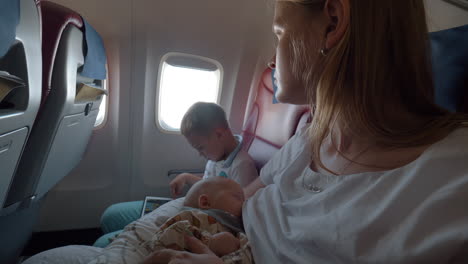 Mother-with-son-and-baby-daughter-flying-by-plane