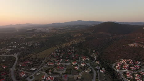 Aerial-scene-of-cottages-green-landscape-with-hills-and-plains-in-Greece