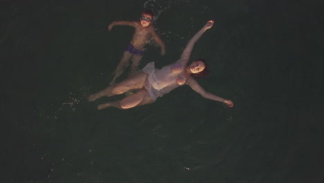 Flying-over-mother-and-son-swimming-in-the-sea