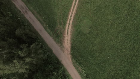 Flying-over-country-road-in-green-field